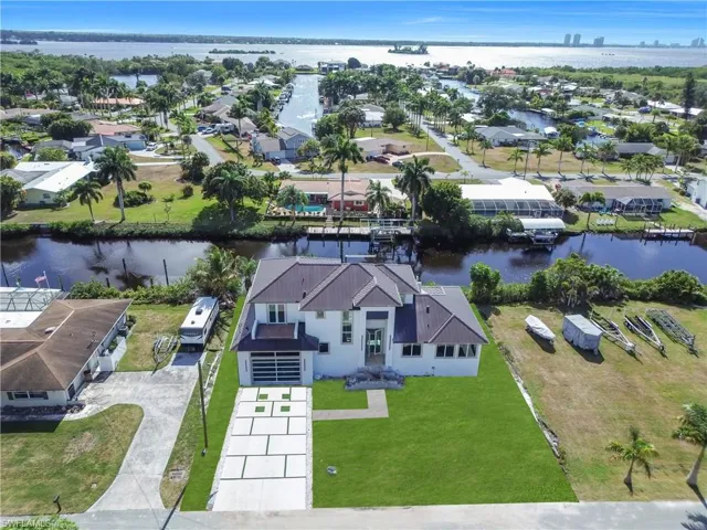 Aerial view of residential area featuring a nearby body of water