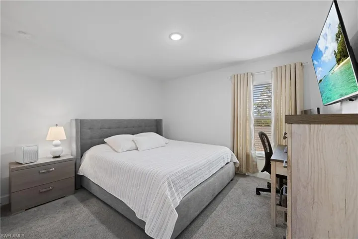 Bedroom with light carpet