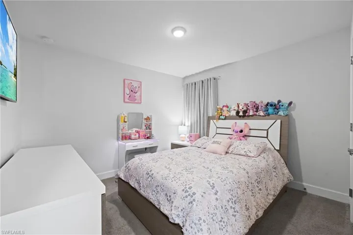 Bedroom with carpet floors and baseboards