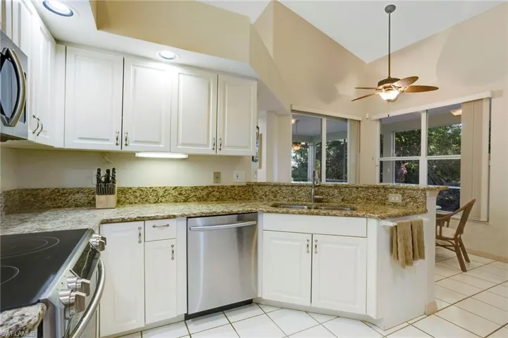 Kitchen features granite countertops and stainless steel appliances