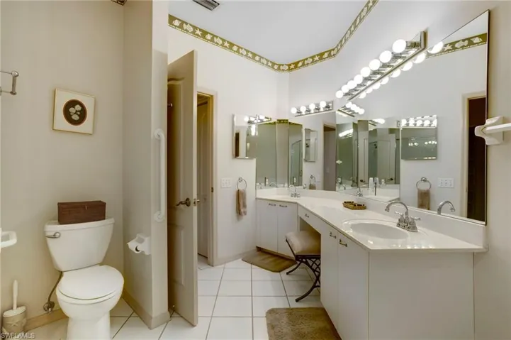 Primary bathroom has long vanity with double sinks