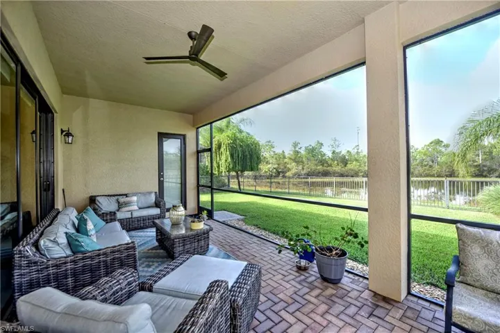 Lanai with ceiling fan and a water view