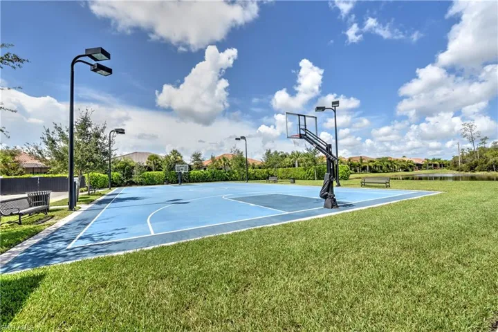 View of basketball court with a yard