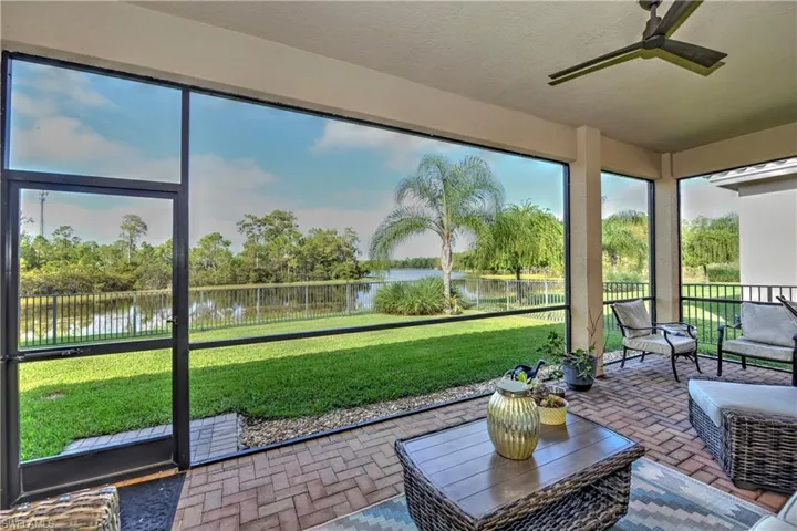 Lanai with ceiling fan and a water view