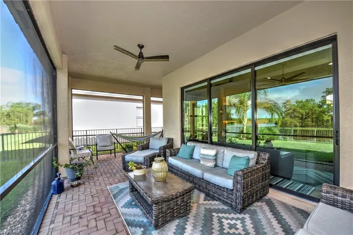 Lanai with ceiling fan and a water view