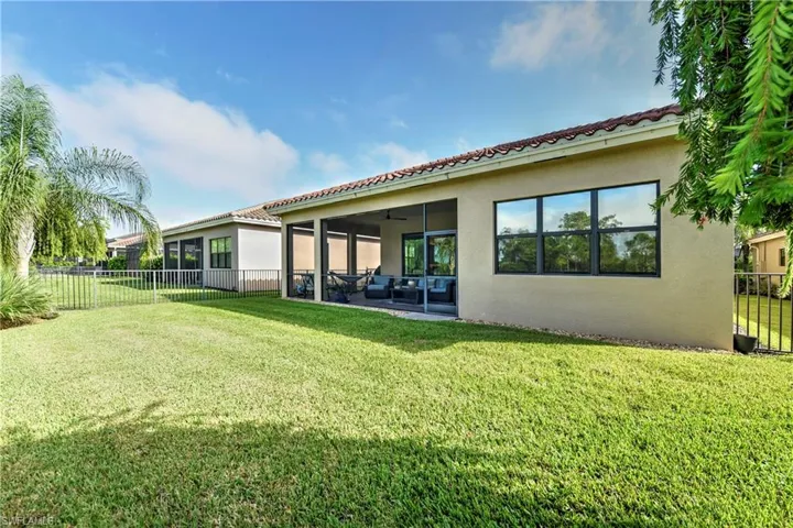Back of property featuring a yard