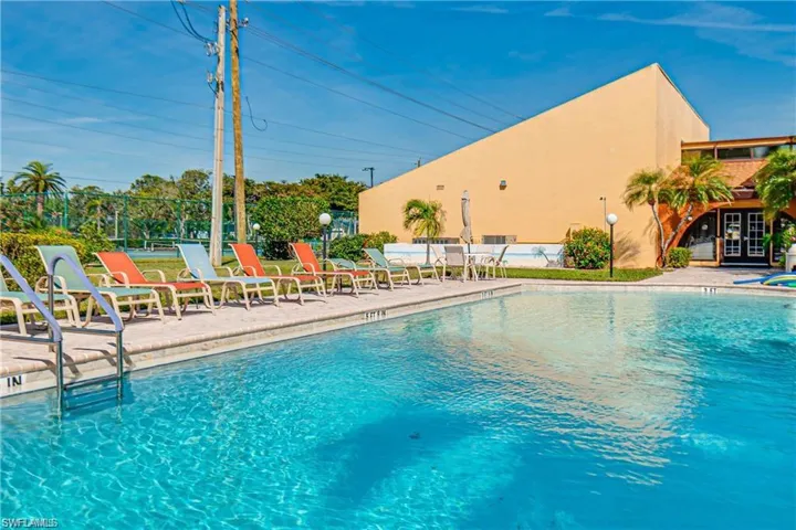 Community pool with a patio