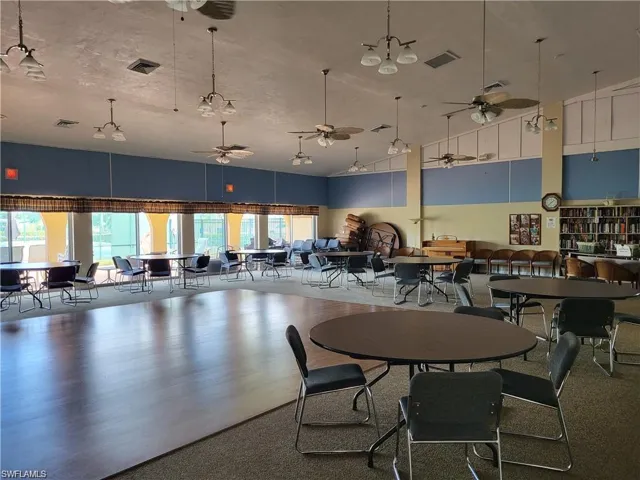 Dining space featuring a towering ceiling and a ceiling fan