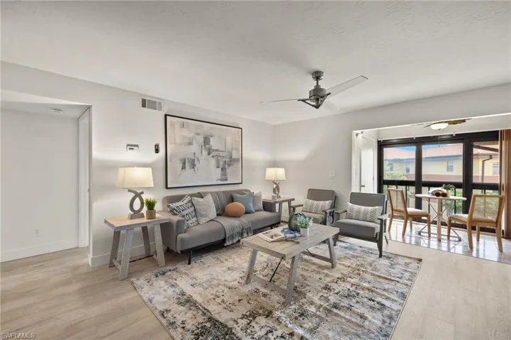 Living room featuring wood finished floors, ceiling fan, and baseboards