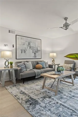 Living area with wood finished floors and ceiling fan