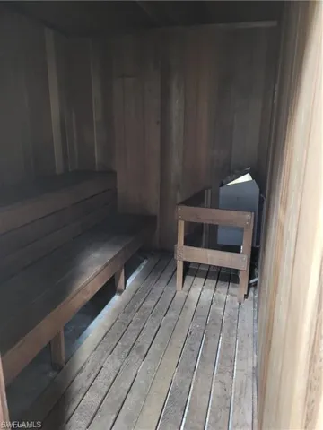 Relaxing sauna with wood-type flooring and wooden walls