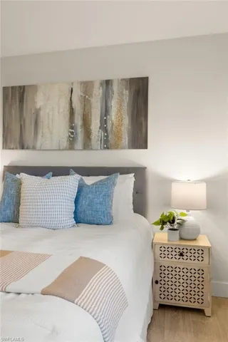 Bedroom featuring wood finished floors and baseboards