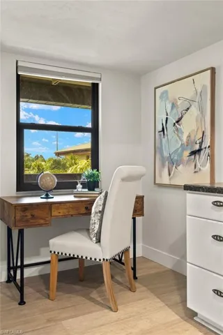 Office space featuring light wood-type flooring and baseboards