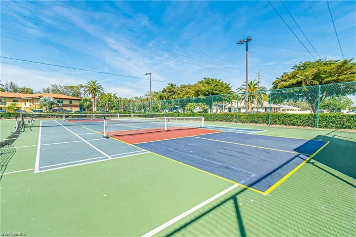 View of tennis court featuring community basketball court