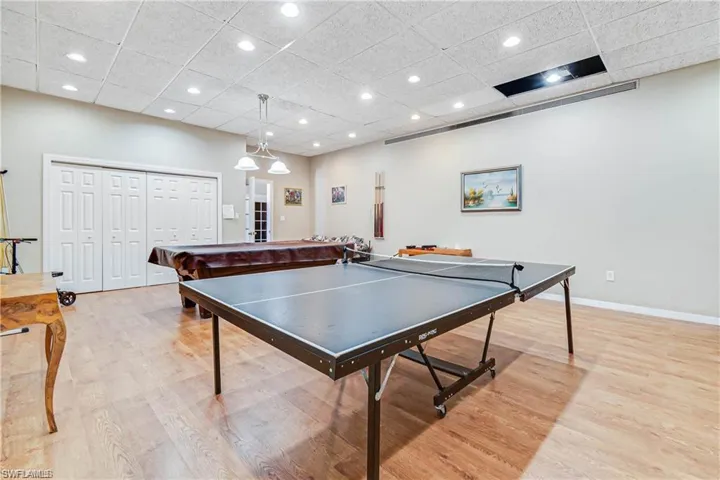 Game room with light wood-style flooring, a paneled ceiling, baseboards, billiards, and recessed lighting