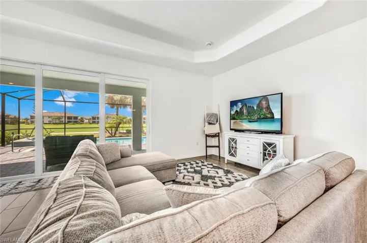 Living room with plenty of natural light and hardwood / wood-style flooring