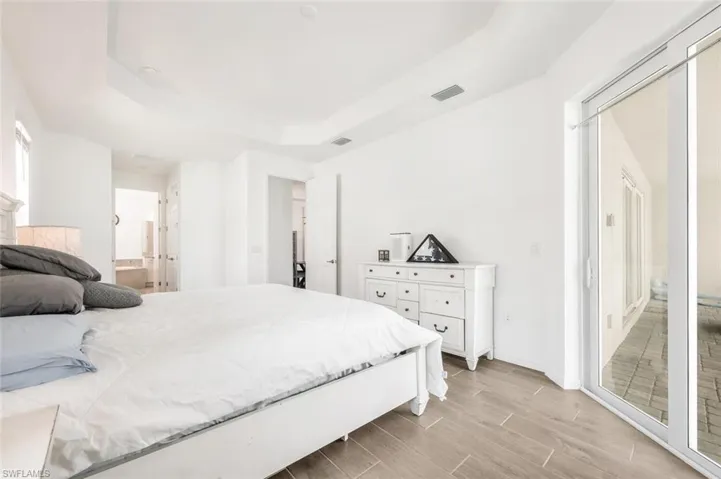 Primary Bedroom with access to the pool & lanai