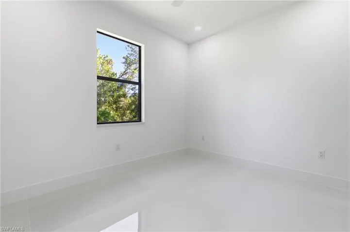 Spare room with recessed lighting and baseboards