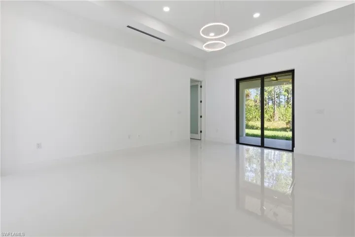 Spare room featuring a raised ceiling and recessed lighting