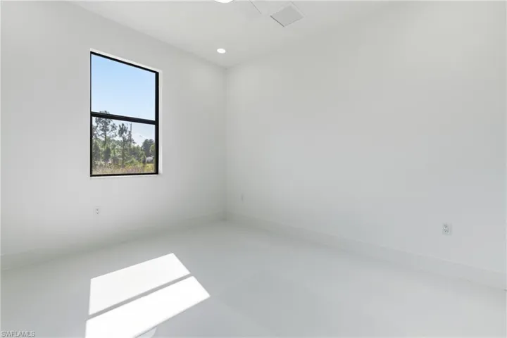 Empty room featuring recessed lighting