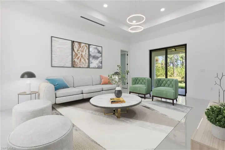 Living area with a raised ceiling and recessed lighting