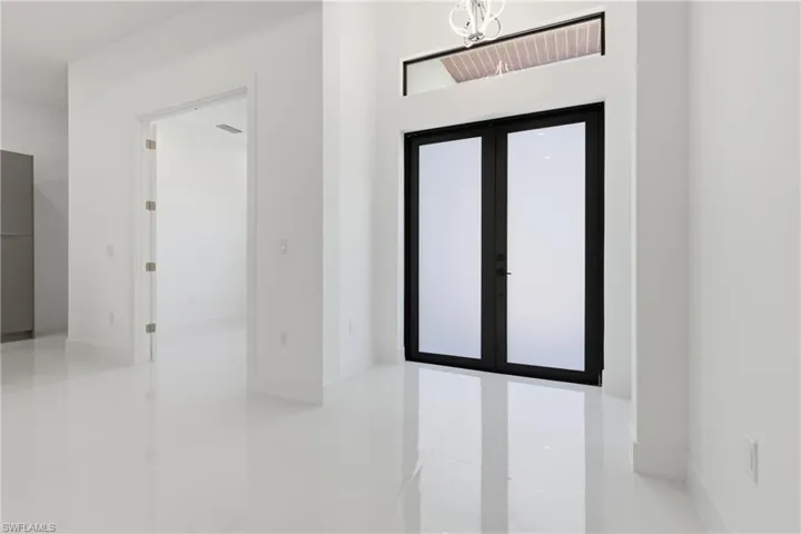 Foyer with french doors and hanging lights