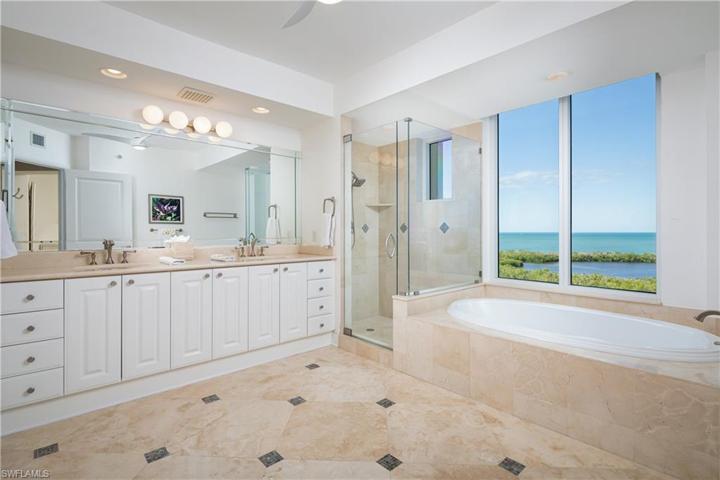 Primary Bathroom with Gulf of Mexico and Inner Clam Bay views from both the separate standing showering and soaking tub.
