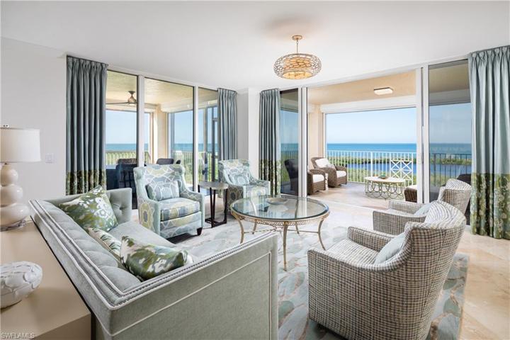 Southwestern angled Living Room photo showcasing Living Room, Center Balcony, Screened in Lanai Dinning Area and Sweeping Gulf of Mexico and Inner Clam Bay Views.