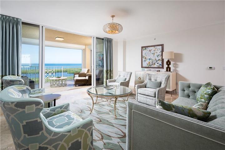 View of Living Room from Kitchen. Direct Western Facing Gulf of Mexico and Inner Clam Bay Views.