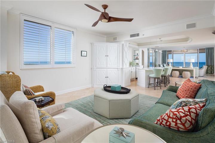 View from back corner of Family Room facing Wine Bar and Living Room. Gulf of Mexico Views are visible from Southern Facing Family Room Window and from Direct Western Facing Center Lanai off of Living Room.