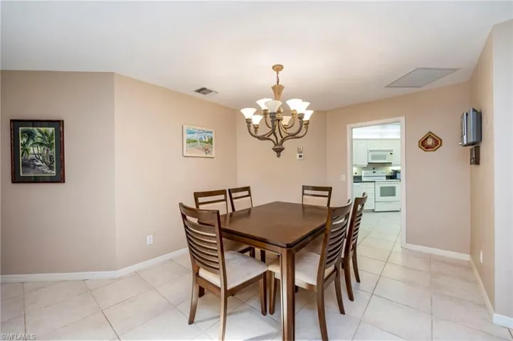 Dining room featuring suspended lighting and light tile patterned floors