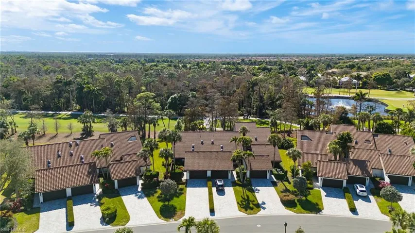 Aerial perspective of suburban area featuring a golf course