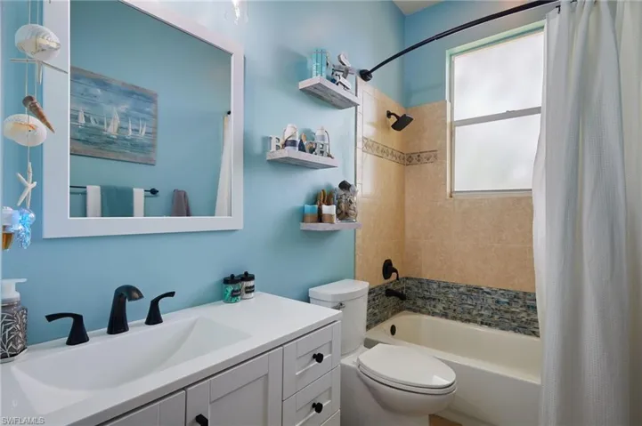 Bathroom with vanity and shower / bath combo