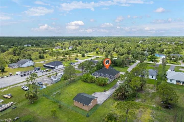 View of property location featuring a forest