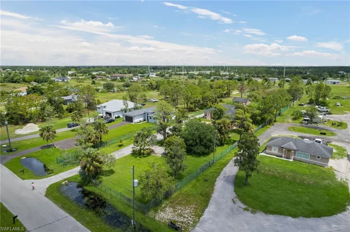 Aerial view of residential area featuring a tree filled landscape
