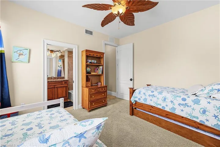 Comfortable room featuring light-colored walls and carpeted flooring