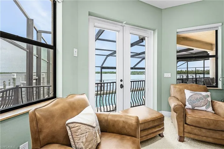French doors and large windows provide expansive water views