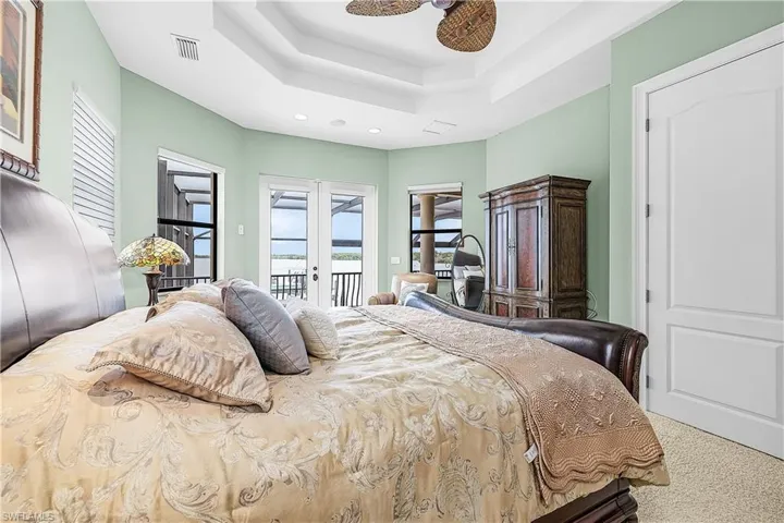 Tray ceiling and ceiling fan with direct outdoor access via French doors