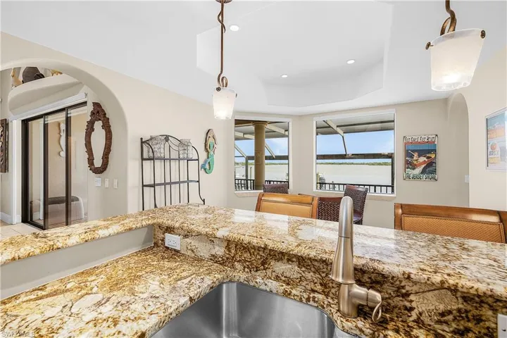 Kitchen featuring a stainless steel sink, brushed nickel faucet, and granite countertops