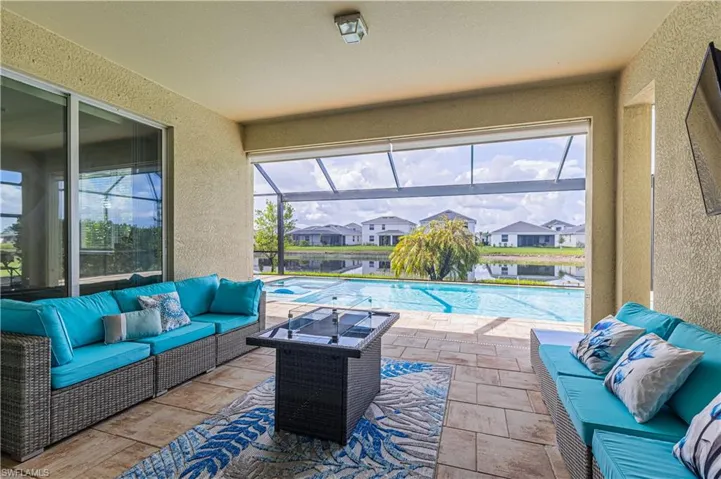 View of patio / terrace featuring outdoor seating, a sunroom, a residential view, and glass enclosure