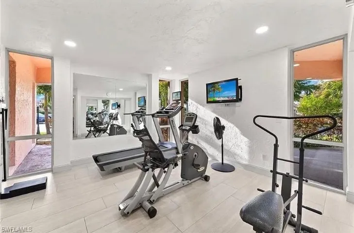 Exercise area with recessed lighting and a textured wall