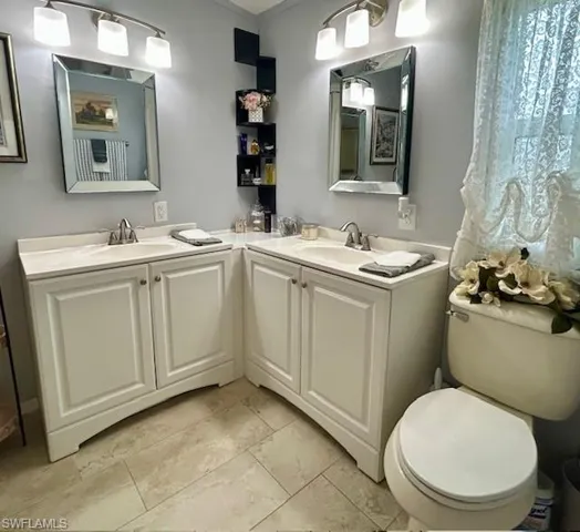 Bathroom with double vanity and toilet