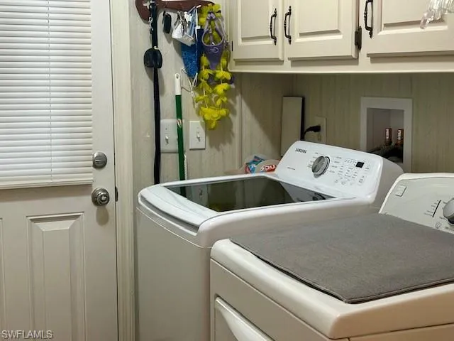 Washroom with washing machine and dryer and cabinet space