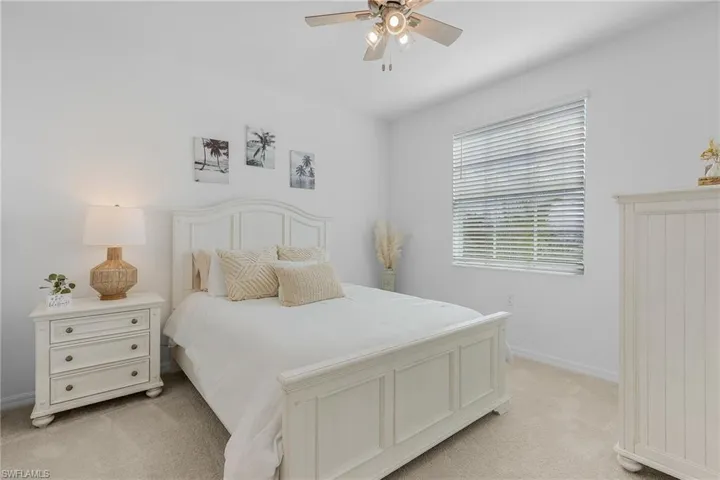 Bedroom with light carpet and ceiling fan