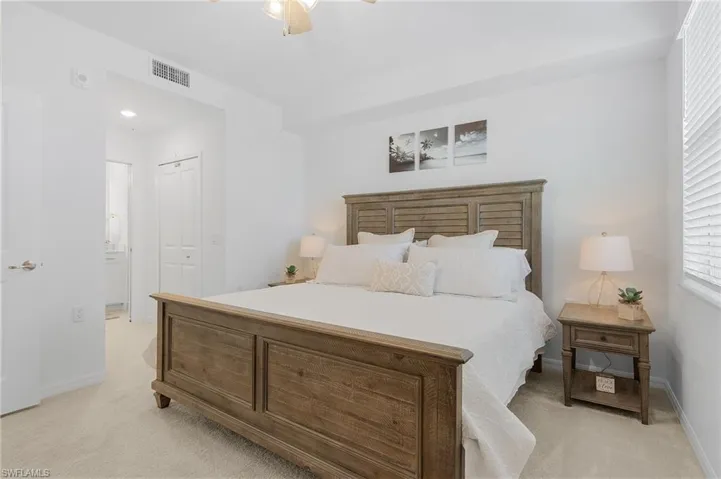 Carpeted bedroom featuring a closet and ceiling fan