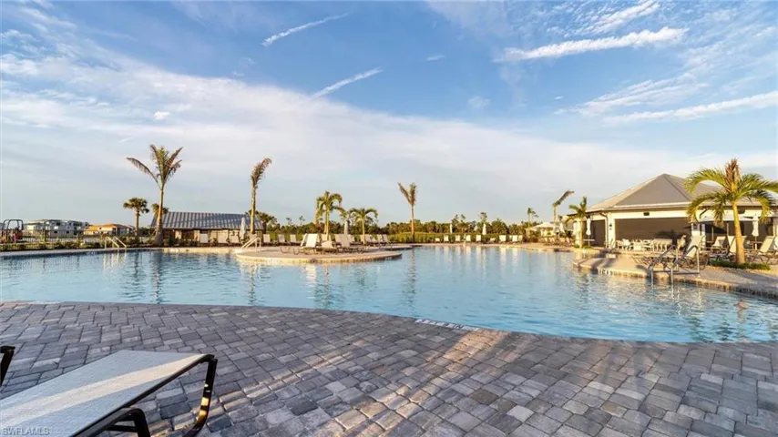 View of swimming pool with a patio area and a water view