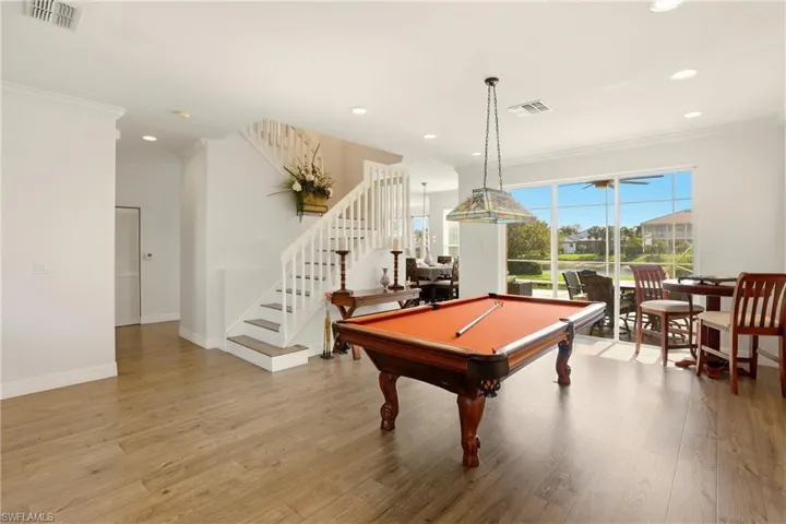 Rec room featuring light wood-style flooring, billiards table, ornamental molding, and recessed lighting