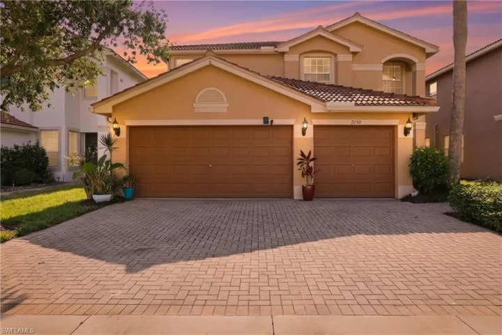 Mediterranean / spanish-style home with decorative driveway, stucco siding, a tile roof, and an attached garage