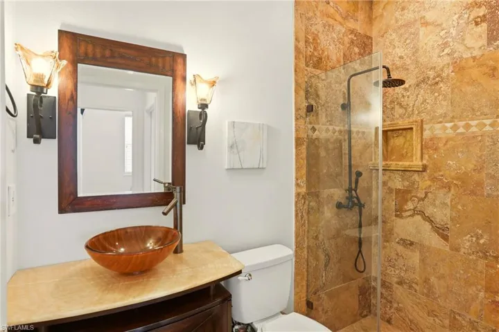 Bathroom featuring a walk in shower and vanity