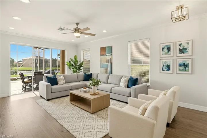 VIRTUAL STAGED Living area featuring hardwood / wood-style flooring, crown molding, ceiling fan, and recessed lighting